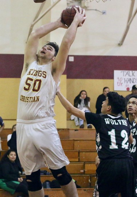 The Crusaders Jonah Bennett attempts a slam dunk against Wonderful College Prep Academy in league play Wednesday in Lemoore.